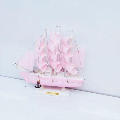 The girl is Mediterranean style pink model sailboat decoration wooden boat plain decoration