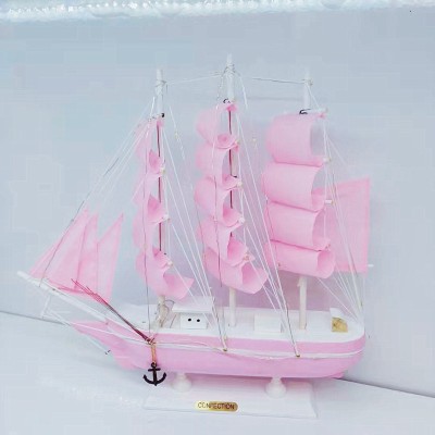 The girl is Mediterranean style pink model sailboat decoration wooden boat plain decoration