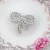 Japan and South Chesapeake new temperament elegant bowknot alloy inlaid pearl joker with brooch sweet South Korean windbreaker ornaments