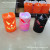 Hold an electronic lighted candle, a Halloween candle, a jack-o '-lantern, and a devil's candle