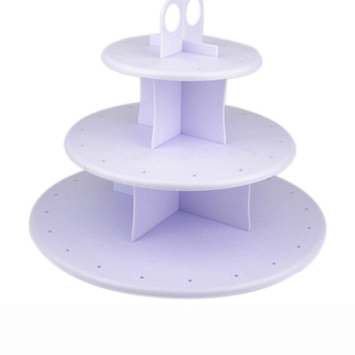 A cake stand A lollipop A plastic cake pop is A three-tiered stand