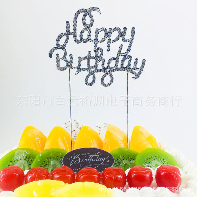 HappyBirthday cake in large cursive with dessert decorations