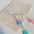 CrossBorder Fashion Color Resin Flower Pearl AntiLost Mobile Phone Charm Women's Short Mobile Phone AntiLost Lanyard