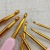 Factory Direct Sales Weaving Tools New Sweater Needle Plastic Handle Gold Aluminum Crochet Hook a Set of 8 Opp Bags